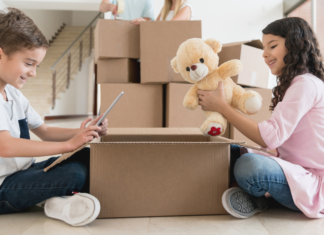 Kids packing boxes to move.