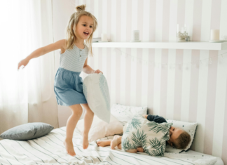 Jumping on the bed.