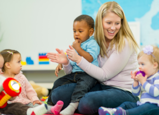 Transitioning From Nanny to Daycare A daycare teacher with toddlers.