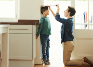 A mom measuring her child's height.