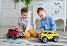 Toddler boys playing with trucks.