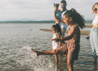 I Just Want to Live on Vacation A family splashing in the water.