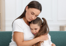 A mom and daughter embracing.