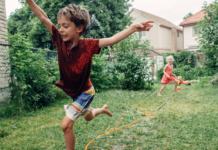 Kids running through a sprinkler.