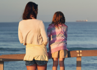 A woman and girl looking out over a dock.