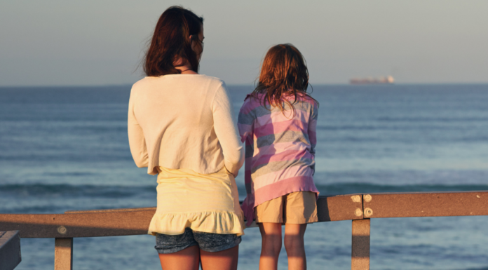 A woman and girl looking out over a dock.