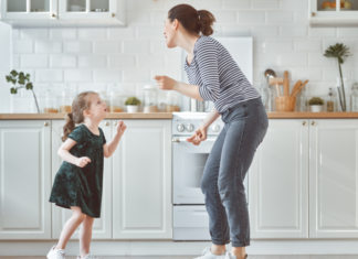 A mom dancing to country music with her daughter.