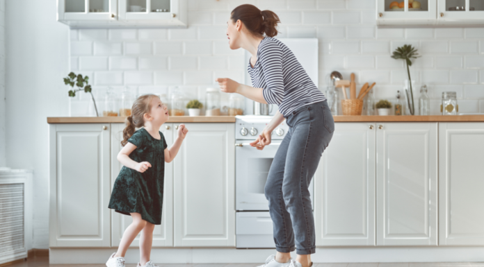 A mom dancing to country music with her daughter.