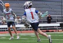 A boy playing lacrosse.