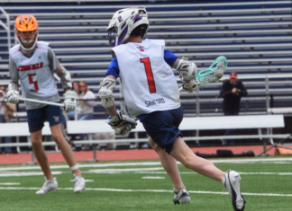 A boy playing lacrosse.