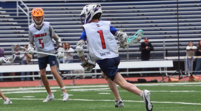 A boy playing lacrosse.