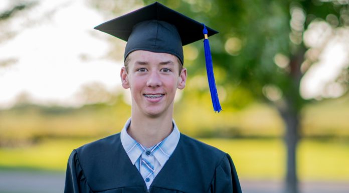 Graduation, How Are We Here? A boy in his graduation cap and gown.