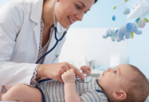 A pediatrician checking a baby.