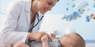 A pediatrician checking a baby.
