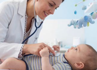 A pediatrician checking a baby.