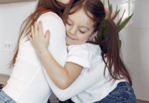 A daughter hugging her mom.