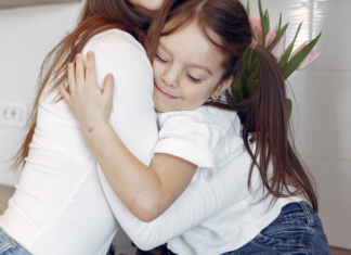 A daughter hugging her mom.