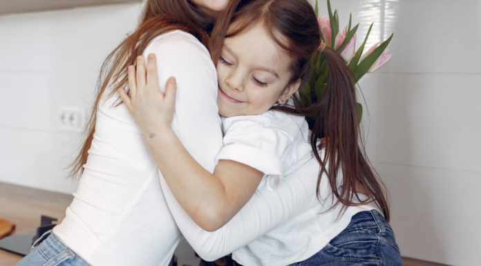 A Wink From the Universe A daughter hugging her mom.