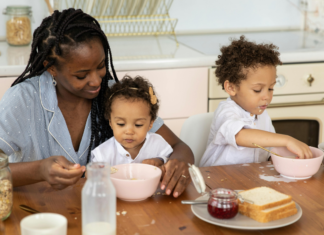 A mother eating breakfast with her children.