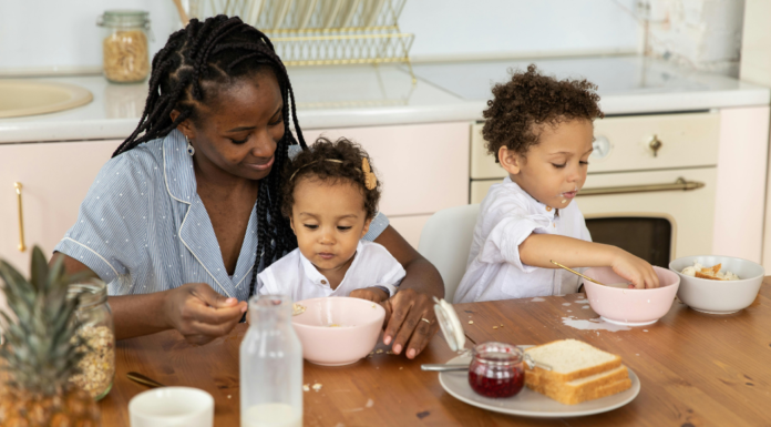 A mother eating breakfast with her children.