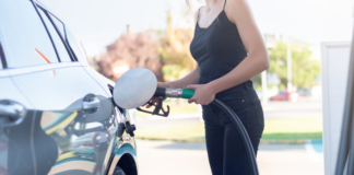 One Tank Trips: Family Adventures Are Just a Short Drive Away A woman pumping gas.
