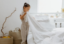 I Banned the H-Word in My House A girl making her bed.