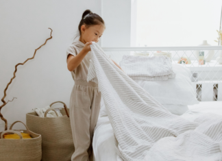 I Banned the H-Word in My House A girl making her bed.