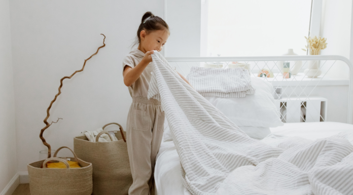 I Banned the H-Word in My House A girl making her bed.