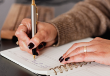 Writing with a pen in a journal.