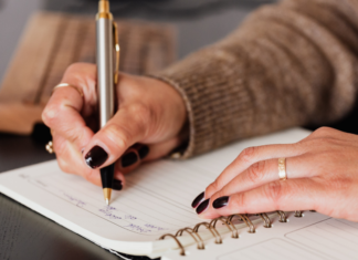 Writing with a pen in a journal.
